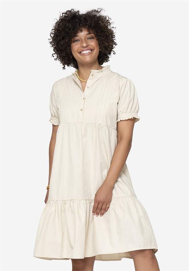 Beige loose nursing dress in organic cotton. , front view